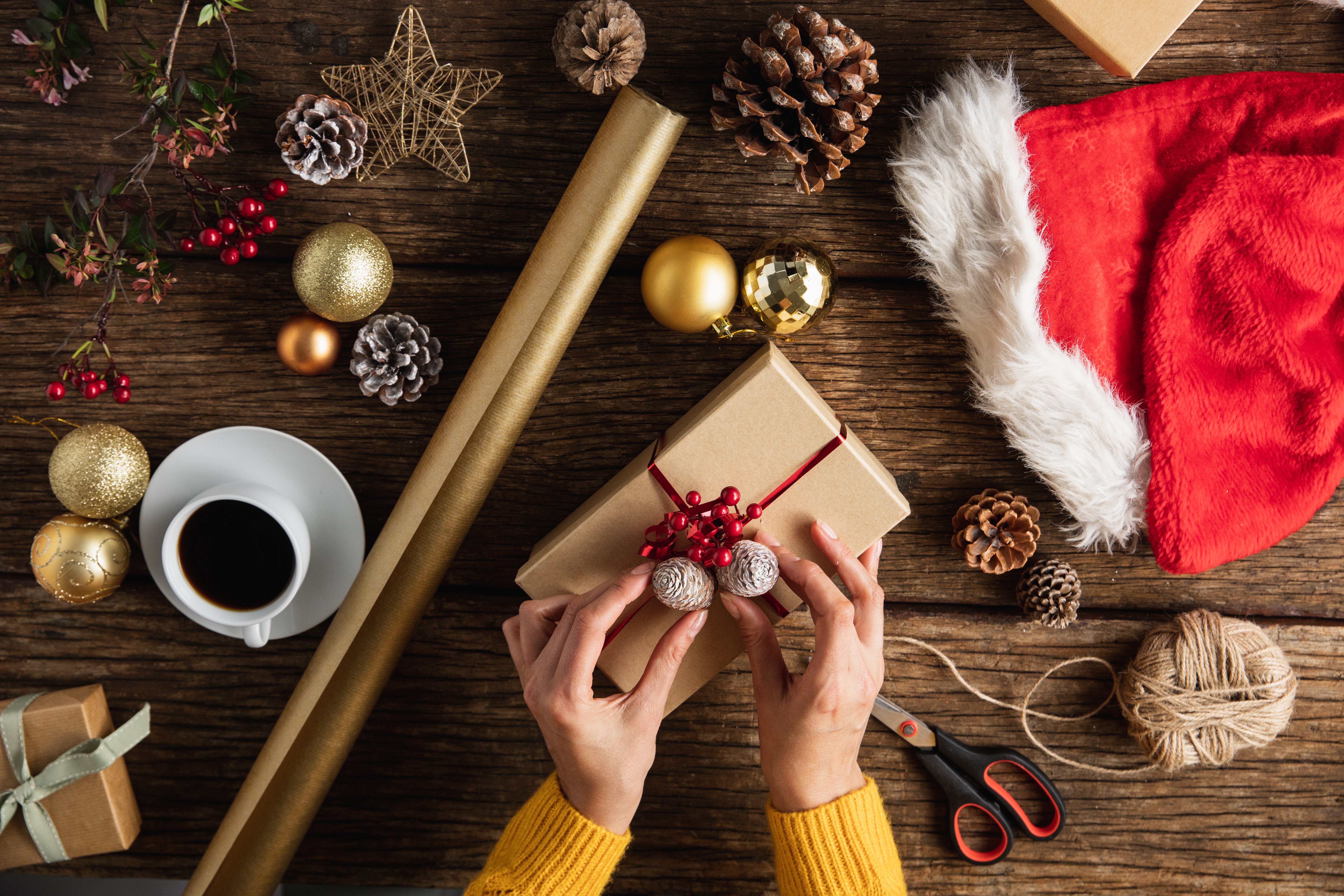 hands-wrapping-christmas-gifts-JZSUYUV
